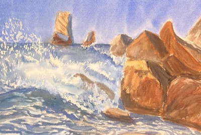 The waves are hitting the rocks