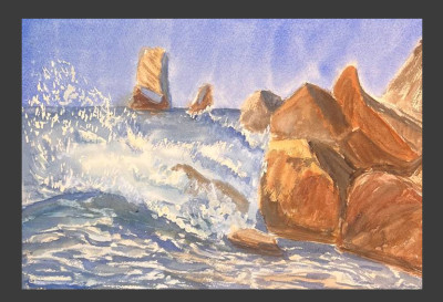 The waves are hitting the rocks